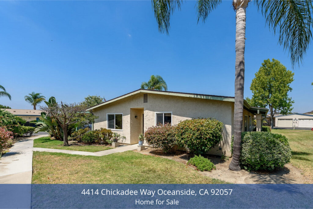 Exterior view of 4414 Chickadee Way Oceanside Home for Sale showing a single-story end-unit condo with stucco walls, manicured landscaping, and palm trees.