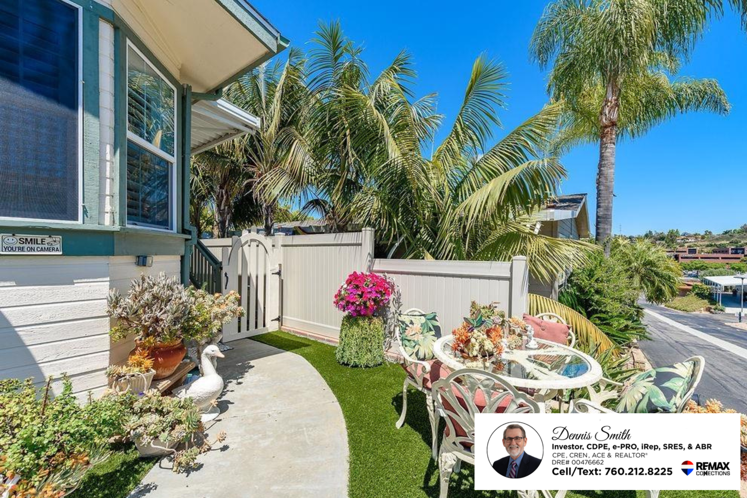 Charming outdoor patio space with tropical landscaping, decorative plants, privacy fencing, and a small outdoor dining set perfect for relaxing, entertaining guests, or enjoying sunny Encinitas weather.